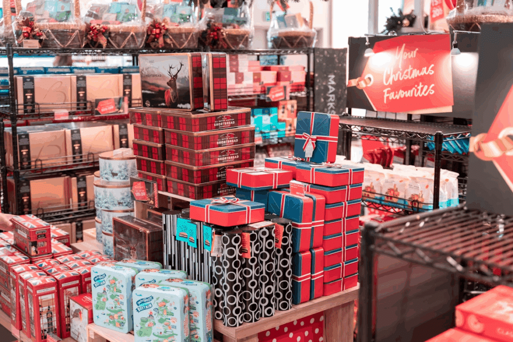 Christmas gifts stacked high in a store display, featuring shortbread, biscuits, and festive packaging. A perfect find for your Christmas checklist shopping.