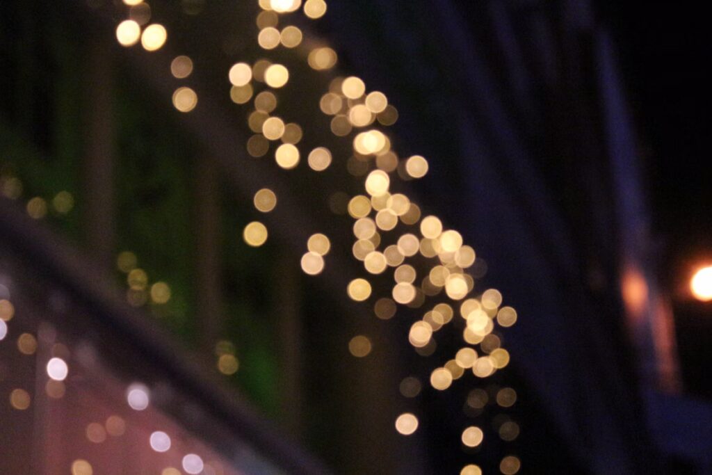 Out-of-focus warm white lights against a dark background.