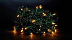 Tangled Christmas lights with warm, glowing bulbs, ready for wrapping outdoor trees with Christmas lights, creating a festive and inviting holiday atmosphere.